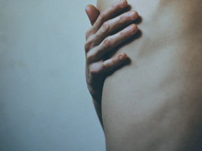 Someone holding sore ribs