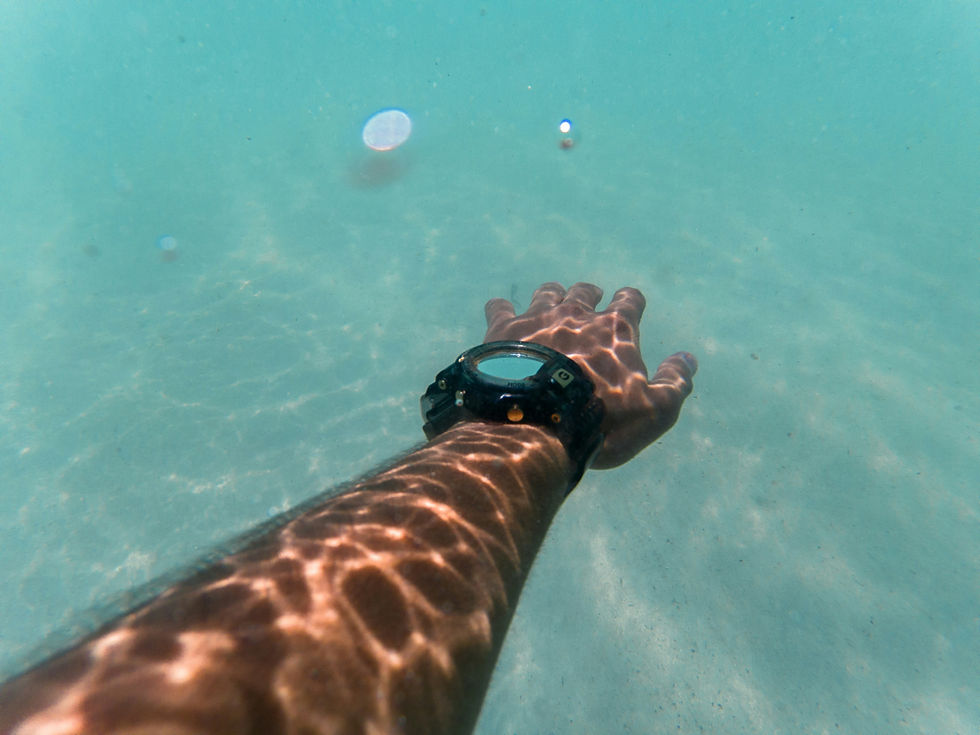 Close-up view of a swimmer’s hand holding a waterproof smartwatch