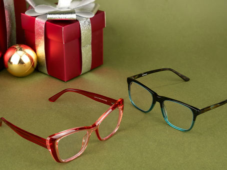 Festive eyeglasses beside Christmas gift boxes, representing holiday eye care and eyewear