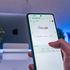 Hand holding a phone showing a Google search results page with Google Ads