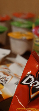 A display of common snacks such as Doritos, Gold Fish and Pringles