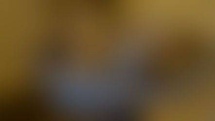 two cats sleeping on a gray cushion