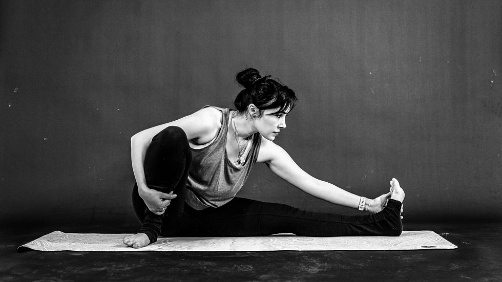 a woman on a yoga mat stretching