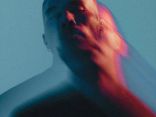 Abstract portrait of a person with motion blur and warm light streaks, symbolizing emotional intensity, identity, and inner struggle. | South Bay Retina, Gilroy, San Jose