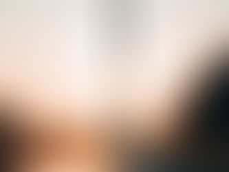 a picture of a person walking beneath the Washington monument at sunset