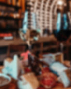 Cheese and charcuterie board with wine glasses, set in a cozy, dimly lit bar. Warm, inviting atmosphere with soft focus on background.