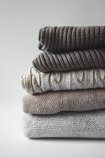 A pile of sweaters on a table