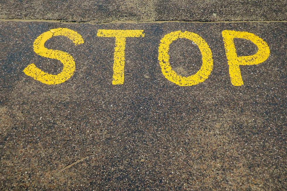 stop sign on a street written in yellow