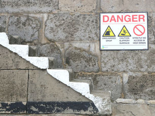 Steps down with a danger notice raising awareness of risks involved