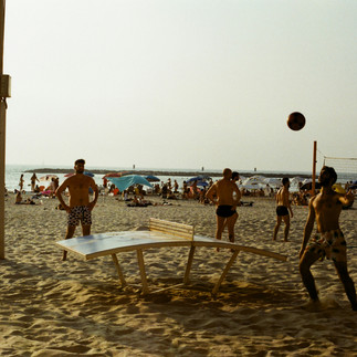 Locals playing Teqball (beach football-table tennis) on the sand in Tel Aviv.