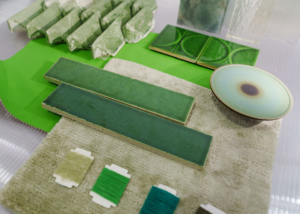 Green tiles and samples on a lime fabric backdrop. Includes yarn cards and a gradated circular dish, creating a cohesive palette.