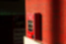 Red fire alarm on a textured wall