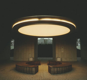 Dimly lit room with two benches facing each other and cement walls representing a quiet invironment Spade And Archer