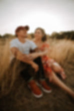 Hispanic couple sitting in a field