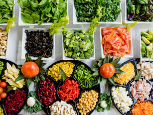 Vibrant spread of dishes featuring lots of fresh vegetables representing stress-reducing foods for calm mind