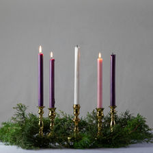Advent wreath with the pink joy candle lit, symbolizing rejoicing in Christ even in hard seasons.