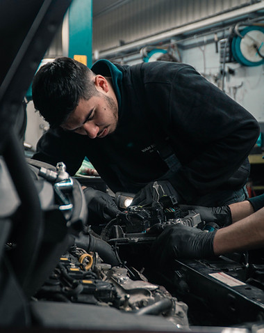 mechanic working on a car engine