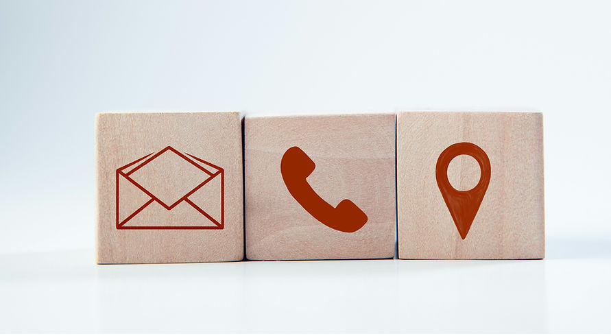 Icons for email, phone and location on wooden cubes.