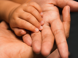 Baby's hand holding Parent's hand