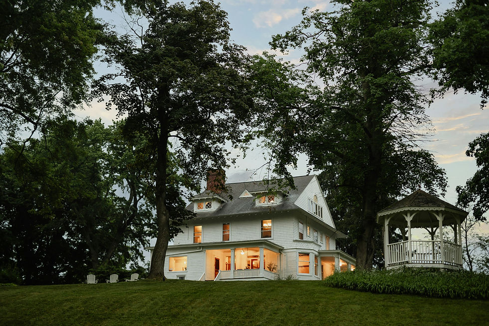 Two-story home with trees in the front yard