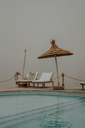 Minimalist sand dunes in the African desert casting sharp, dark shadows.