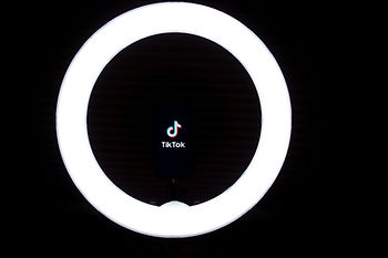 TikTok logo with a light ring around it.