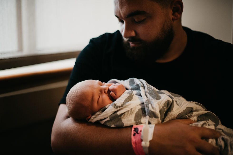 Father holding newborn baby
