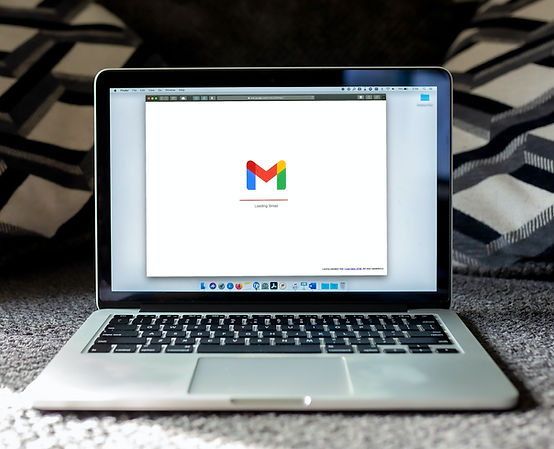 Laptop displaying Gmail loading screen, representing email communication and marketing.