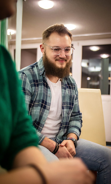 Support worker welcoming a person during a mental health placement assessment.