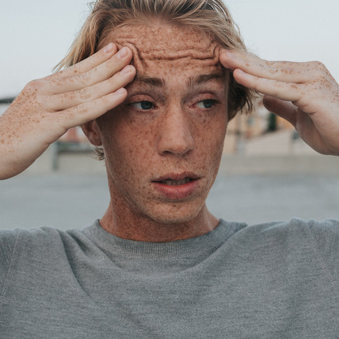 A man stressed out with his hands on his head