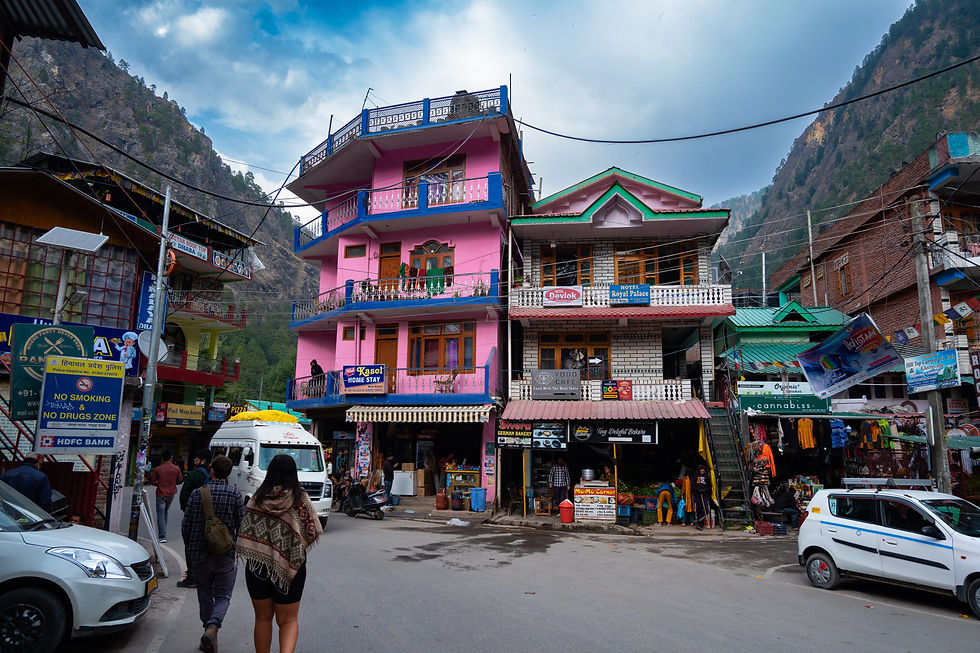 The bustling main market of Kasol, Himachal Pradesh, India, with colorful shops and stalls selling a variety of items, including the famous Hippy Market known for its unique handmade crafts and clothing