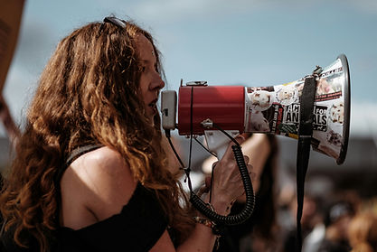 Woman in side profile speaking in to loud hailer