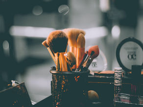 Makeup and personal care products representing environmental hormone exposure, estrogen burden, and endocrine-disrupting chemicals.