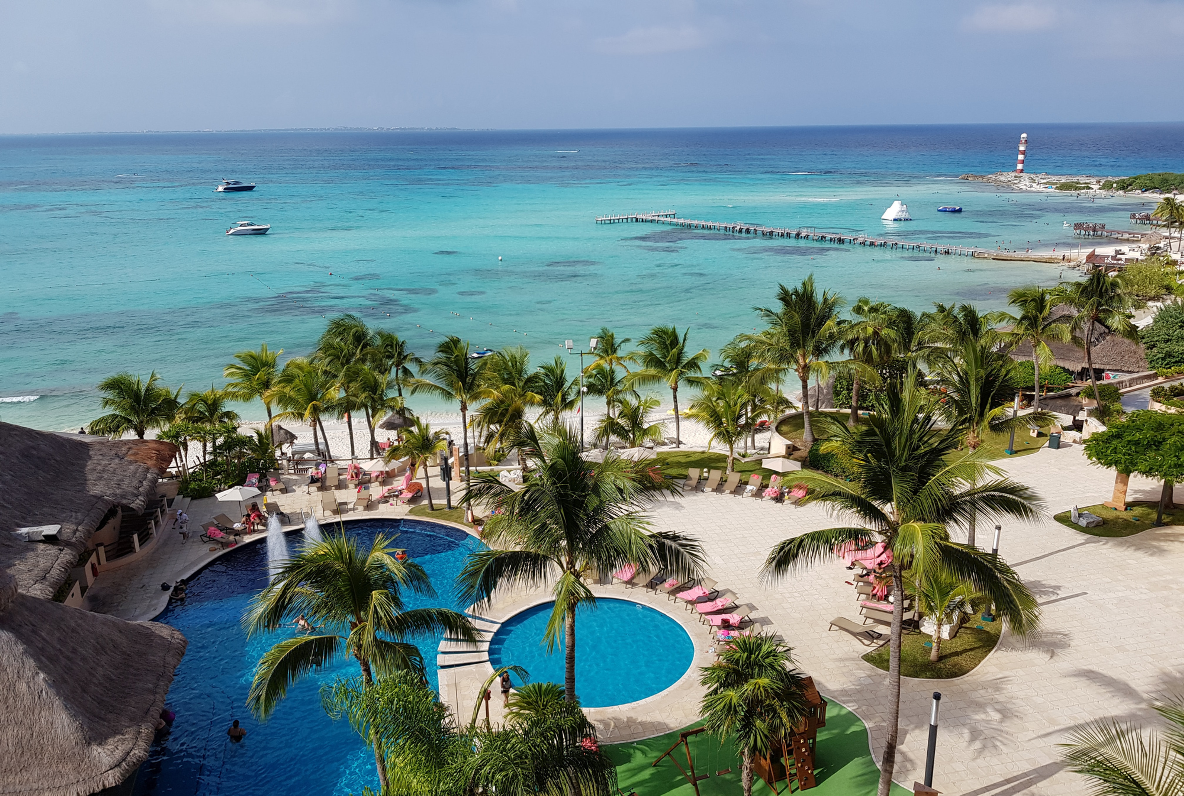 Overview of luxury all-inclusive resort pool and beach for destination wedding group room block