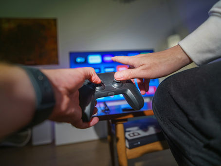 Person using a console controller in front of a monitor