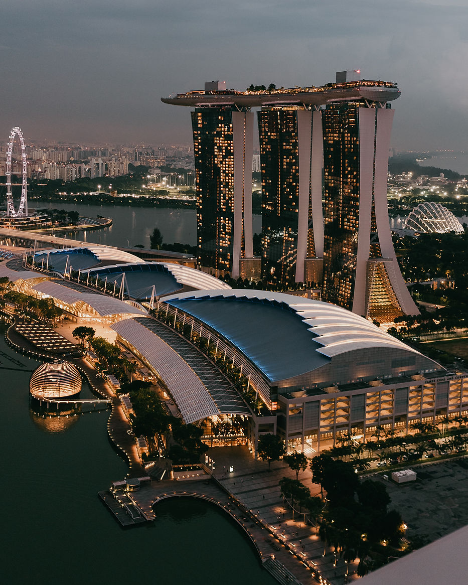 Aerial view of the Marina Bay Sands hotel and surrounding Singapore landmarks at night