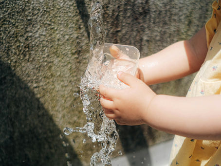 A child getting water from a public water fountain