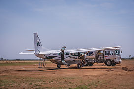 Light aircraft landing in Serengeti for fly-in Tanzania safari and Zanzibar beach holiday