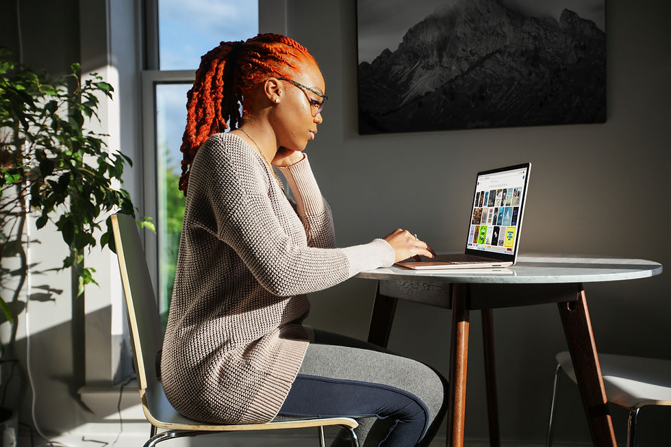 woman sitting at laptop, working remotely.