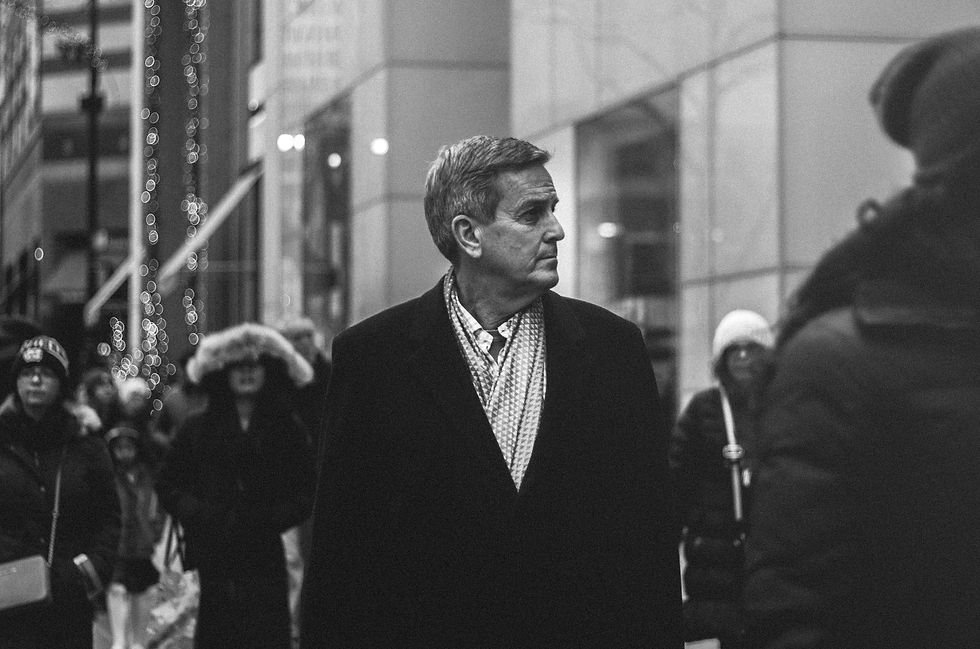 A professional photo of Attorney Brian White standing confidently in his law office, wearing a suit and smiling warmly at the camera.