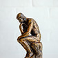 a statue in thinking pose signifying thought patterns