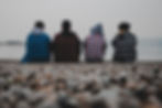 Teenagers sitting on the beach