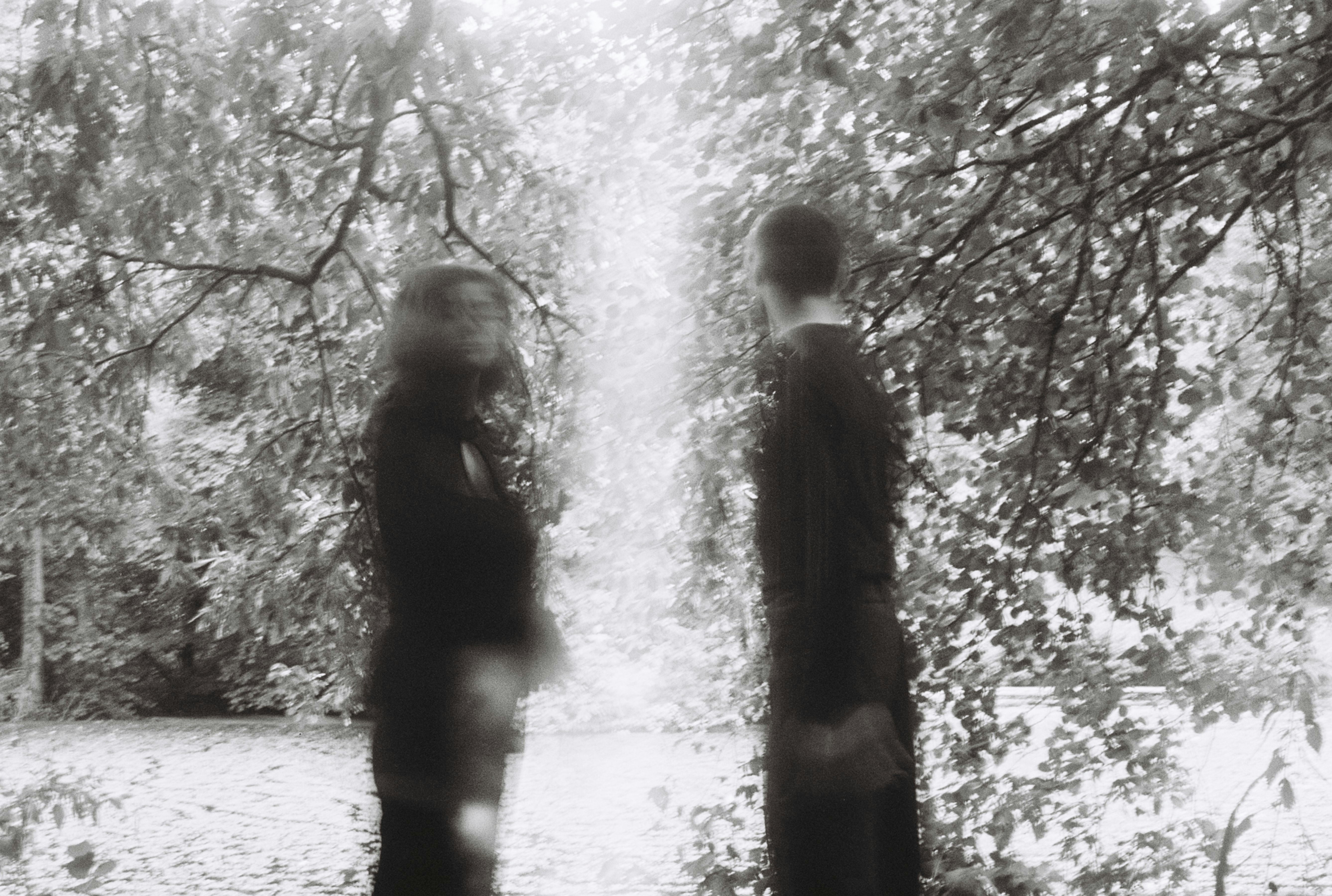 Two blurry figures on a path, an intuitive journey.
