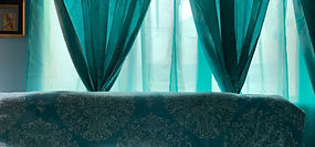 Clean delicate drapery can tie a room together. 