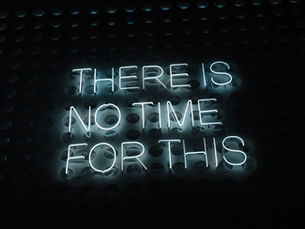 neon lit lettering with the words "there is no time for this" (the subtext is you don't have time for AI brain fry)