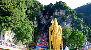 The golden statue and rainbow staircase at Batu Caves near Kuala Lumpur