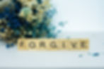 steps in trauma recovery - Scrabble tiles spelling forgive