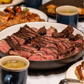a feast with steak centerpiece