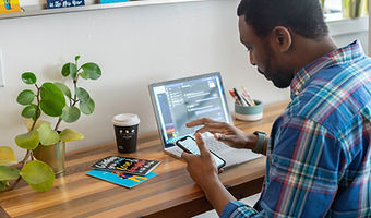 Office worker at his computer, participating in a virtual team meeting. 