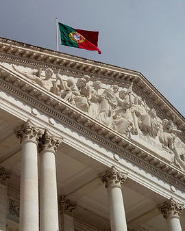 Portuguese flag on courthouse building representing constitutional basis of class actions in Portugal.